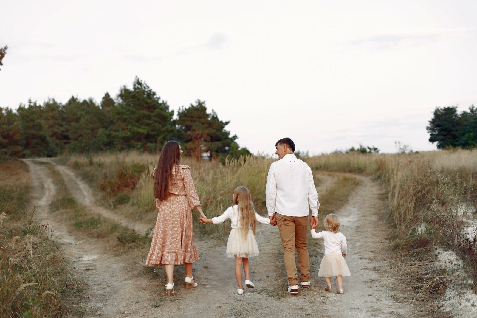 cute family playing in a autumn field