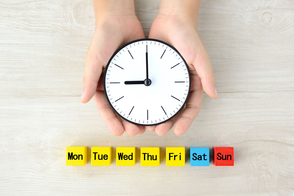 Happy child with clock managing anxiety routine