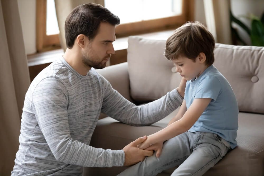 Parent supporting anxious child at home before therapy